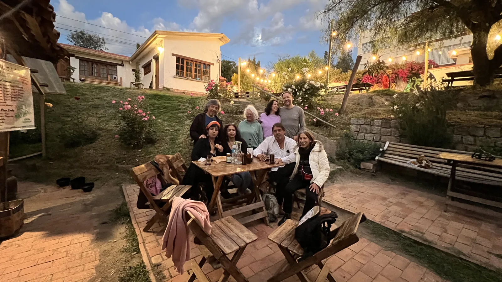 People gathered in the garden of Proyecto Cultural Barranco at dusk.